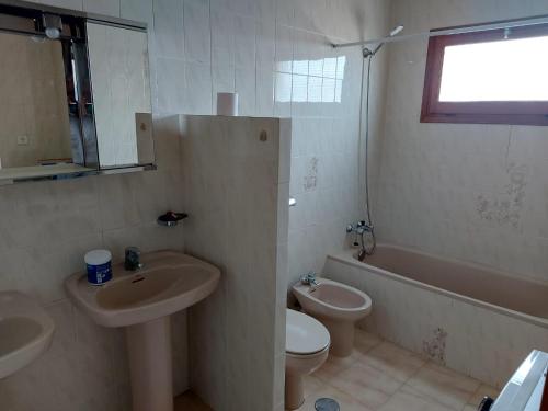a bathroom with two sinks and a toilet and a tub at Amazing view villa in Calpe