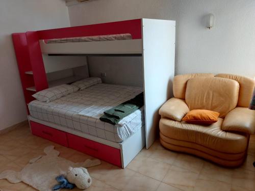 a bedroom with a bunk bed and a chair at Amazing view villa in Calpe