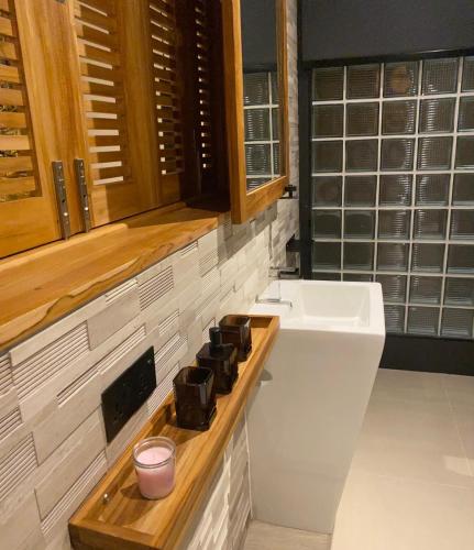 a bathroom with a sink and a toilet and a counter at Villa Miario in Koh Samui