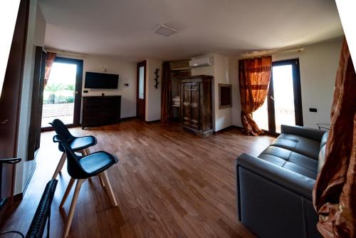 a living room with a couch and a chair at Apulia House in Bisceglie