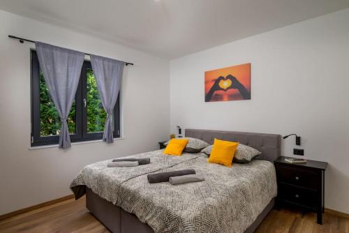 una camera da letto con un letto grande con cuscini gialli di Villa Bepo by IstriaLux a Marčana