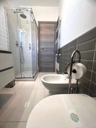 a bathroom with a shower and a sink and a toilet at ROMA AIRPORT SKY Apartments in Fiumicino