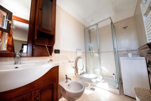 a bathroom with a sink and a toilet and a shower at Apulia House in Bisceglie