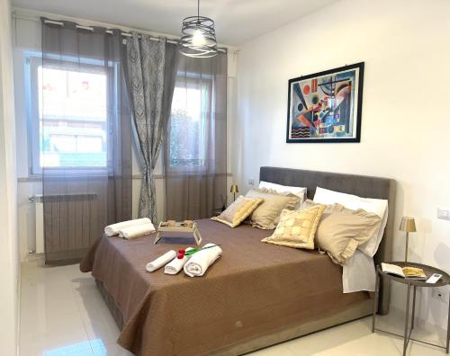 a bedroom with a large bed with pillows on it at ROMA AIRPORT SKY Apartments in Fiumicino