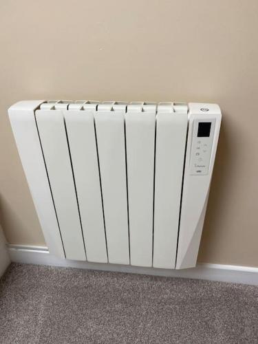 a white radiator in a corner of a room at Corran Meadbh in Lahinch