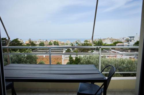 a bench on a balcony with a view of a city at Panoramic White Blue in Chios