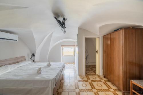 a bedroom with a bed with two stuffed animals on it at Gió home in Santa Maria al Bagno