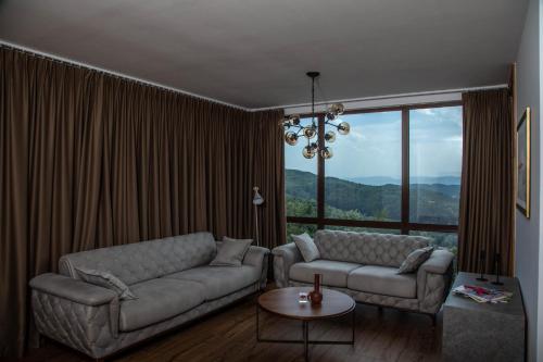 a living room with a couch and a table at Vila Ana in Kalesija