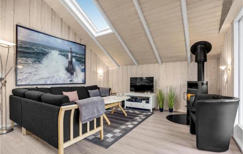 a living room with a couch and a tv at Holiday Home Flejmose Sydals X Denmark in Kegnæshøj