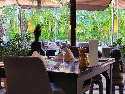 a table in a restaurant with wine glasses on it at La Villa Boutique Hotel in Accra