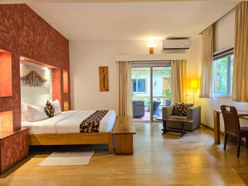 a bedroom with a bed and a desk and a chair at La Villa Boutique Hotel in Accra
