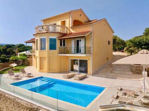 a villa with a swimming pool in front of a house at Estasia Luxury Villa with private pool by DadoVillas in Kommeno