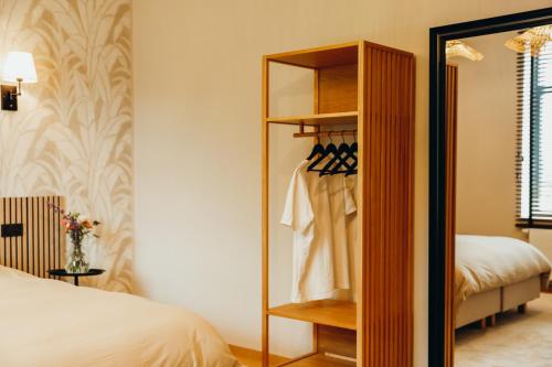 a bedroom with a closet with a bed and a mirror at Madame Crepin in Rochefort