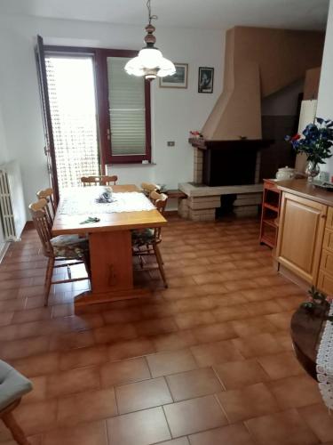 a dining room with a table and chairs and a fireplace at CASA di PIERO in Monte San Pietrangeli
