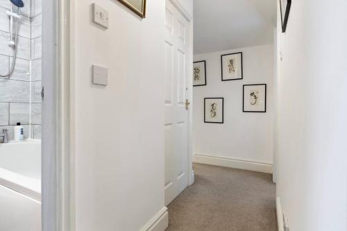 a white bathroom with a sink and a tub at Pass the Keys 4 35 Fossgate Cosy Central 2-Bed Home Right in the Heart of York in York