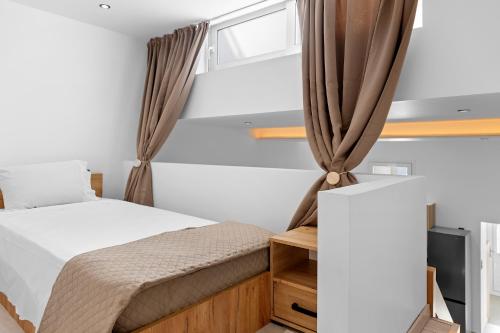 a small bedroom with a bed and a window at Villa Chris - Malona in Malona Village