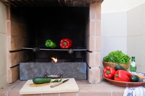 a brick oven with peppers and vegetables on a counter at City center, private parking, AC, 6ppl. in Olhão