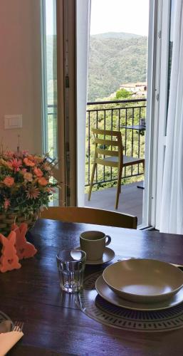 a table with a plate on a table with a view at Da Arturo e Maruca suites con 2 camere in Vellano