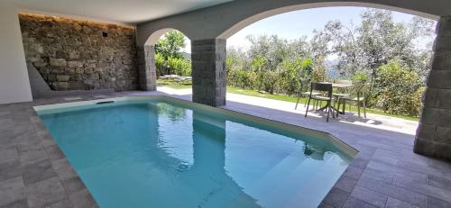a swimming pool in a villa with a patio at Da Arturo e Maruca suites con 2 camere in Vellano