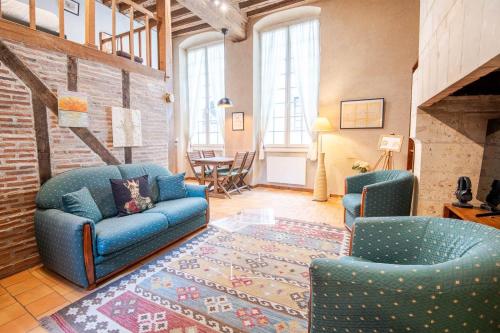 un salon avec un canapé bleu et deux chaises dans l'établissement Le Typique Tourangeau, à Tours
