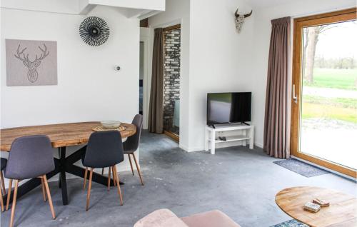 a living room with a table and a tv at Gorgeous Home In Ijhorst With Kitchen in IJhorst
