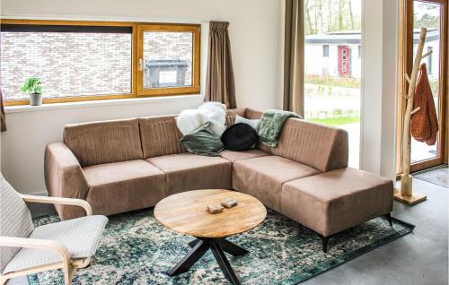 a living room with a brown couch and a table at Gorgeous Home In Ijhorst With Kitchen in IJhorst
