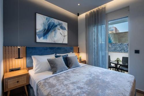 a bedroom with a king sized bed and a window at Santa Marina Luxury Apartments #1 with pool in Asgourou