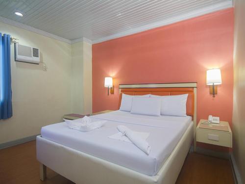 Ένα ή περισσότερα κρεβάτια σε δωμάτιο στο WinMin Transient Inn