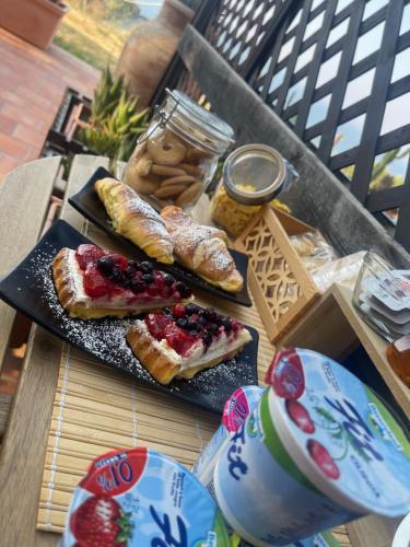 a table with two plates of bread and pastries at B&B La Torre in Realmonte