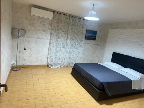 a bedroom with a large bed in a room at Missori home 1 in Catania