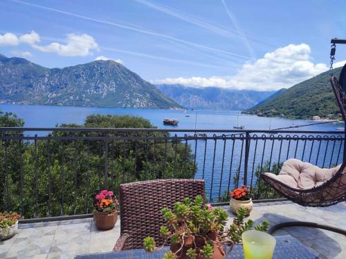 a balcony with a view of a lake and mountains at Villa Terrazza in Donji Morinj