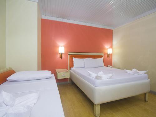 Ένα ή περισσότερα κρεβάτια σε δωμάτιο στο WinMin Transient Inn