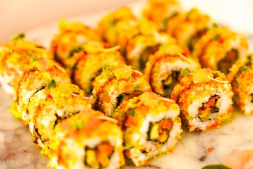 a plate of food with sushi on a table at Hotel Mayura in Raipur