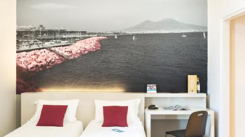 a bedroom with a wall mural of a beach at B&B Hotel Napoli in Naples