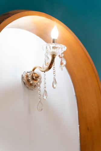 a chandelier with a light on a wall at Villa del Pino, Terrazza vista Mare in Minturno