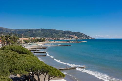 a view of a beach with boats in the water at B&B HOTEL Diano Marina Palace in Diano Marina