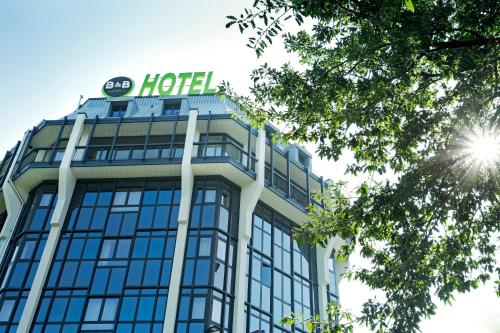 a building with a hotel sign on top of it at B&B Hotel Milano San Siro in Milan