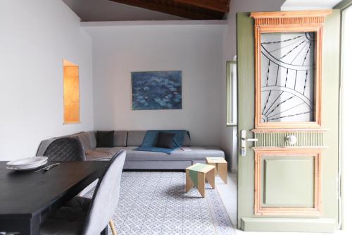 a living room with a table and a couch at La Piccola Casa in Aegina Town