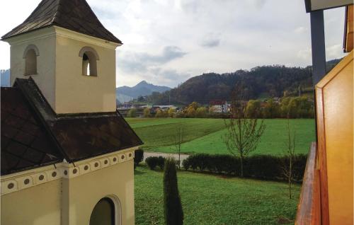 a church tower with a view of a green field at Stunning Apartment In Lasko With Wifi in Laško