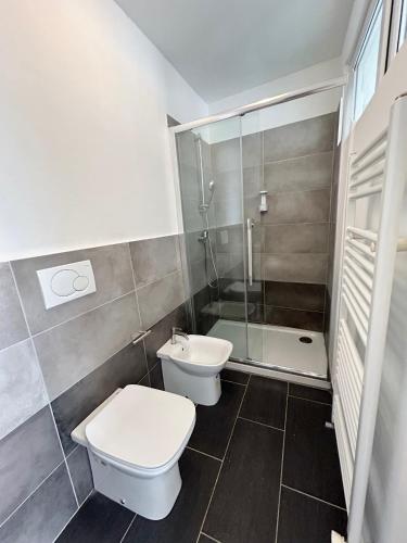 a bathroom with a toilet and a sink and a shower at Residence Zar 7 in Trieste