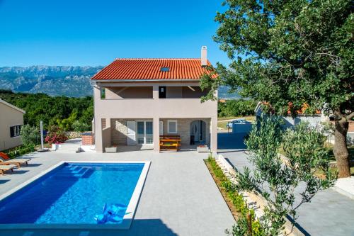 a villa with a swimming pool and a house at Villa Macanovi dvori with private pool in Knežević