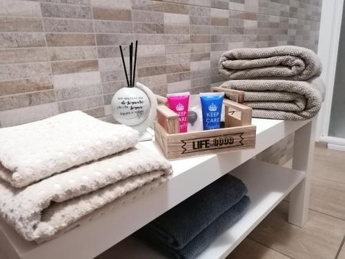 a white shelf with towels and other items on it at B&B San Francesco in Molfetta