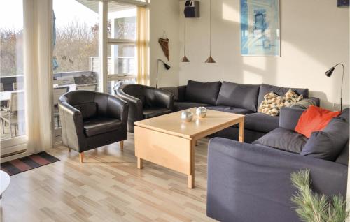 a living room with a couch and two chairs and a table at Holiday Home Strandparken in Otterup