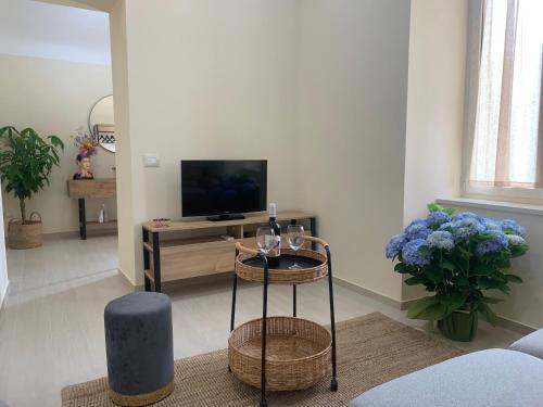 a living room with a television and a table at La Primavera Apartment in Ercolano