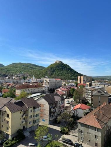 a city with buildings and a mountain in the background at Yoa apartaments in Deva