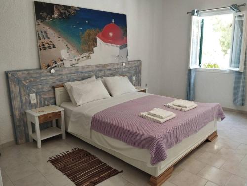 a bedroom with a bed with two towels on it at Hotel Finiki View in Foinikion