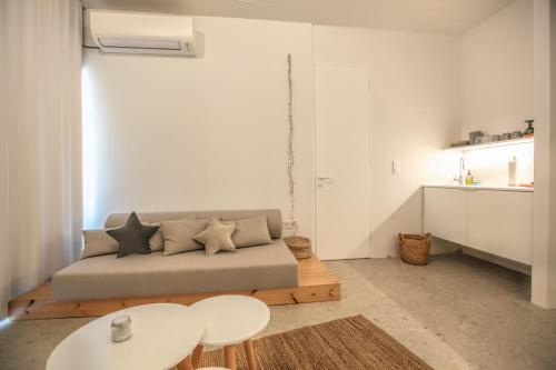 a living room with a couch and a table at Convent-Βand Αpartment in Kalabaka