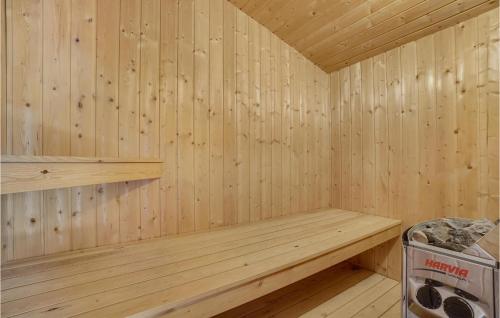 a wooden sauna with a bench and a trash can at Cozy Home In Roslev With Wifi in Roslev