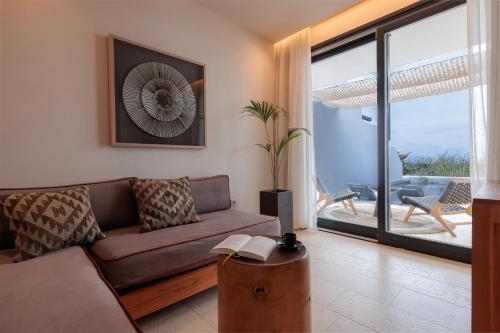a living room with a couch and a table at Asty Mykonos Hotel & Spa - World of One Hotel Group in Mýkonos City