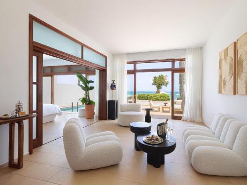 a living room with a view of the ocean at Amirandes, A Grecotel Resort to Live in Gouves